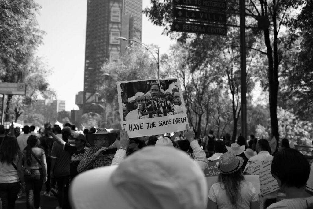 greyscale photo of people protesting hate